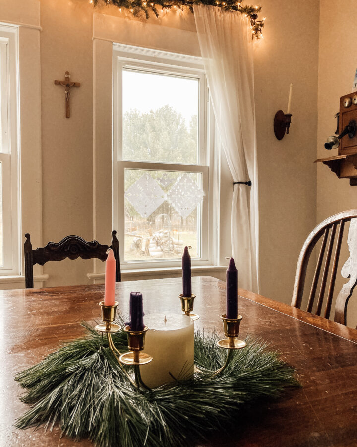 advent wreath with fresh greens on dining room table